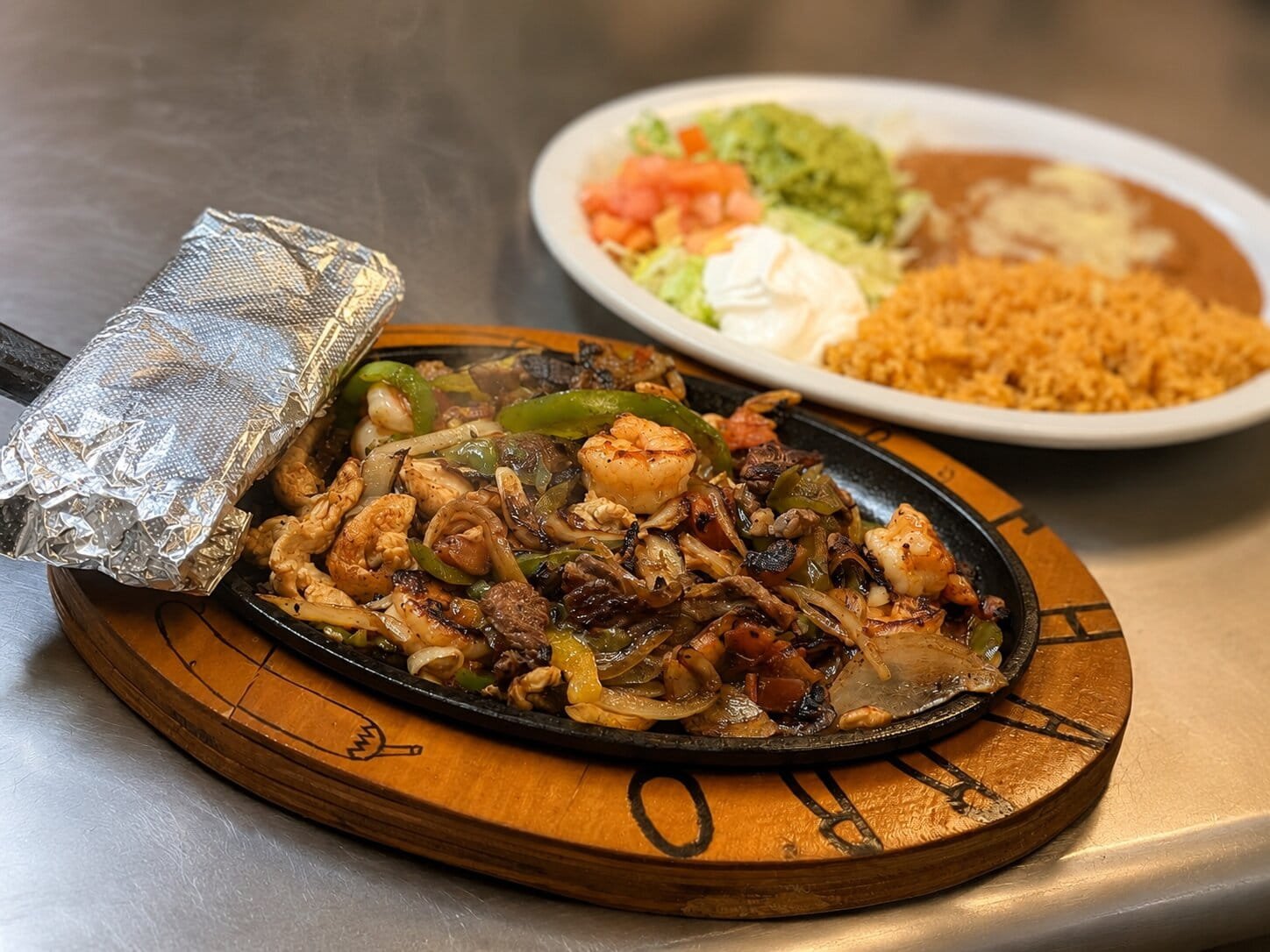 Sizzling fajitas served with traditional sides at El Charro Mexican Restaurant